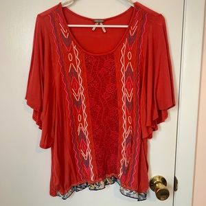 Orange blouse with aztec print and lace details